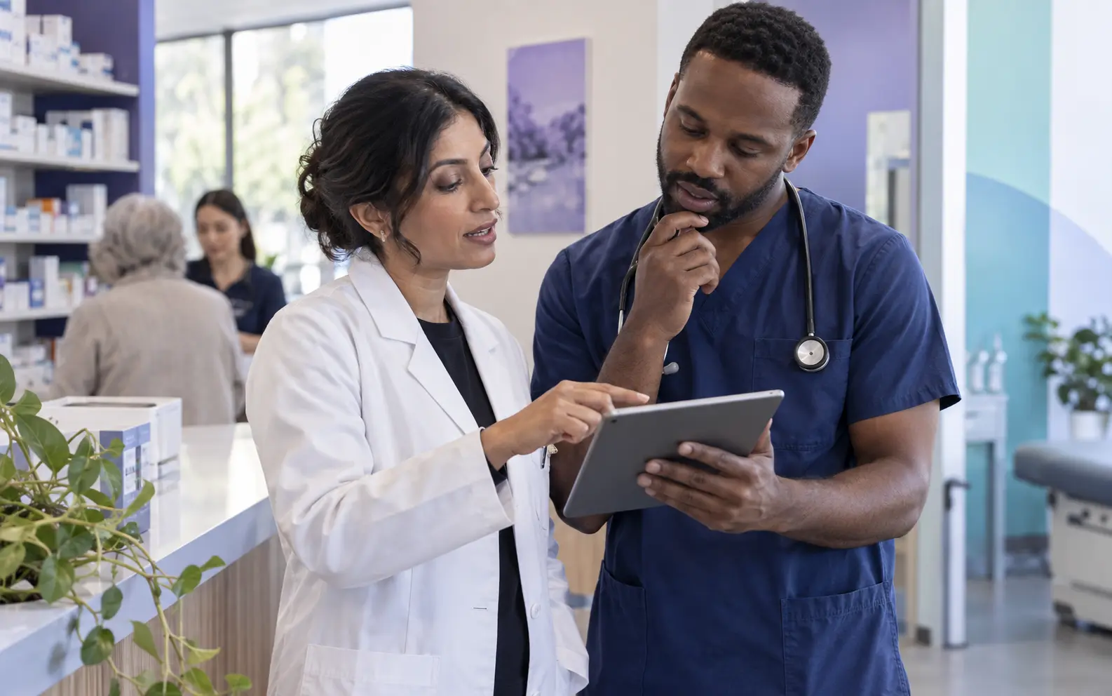 A pharmacist and clinician reviewing patient context together